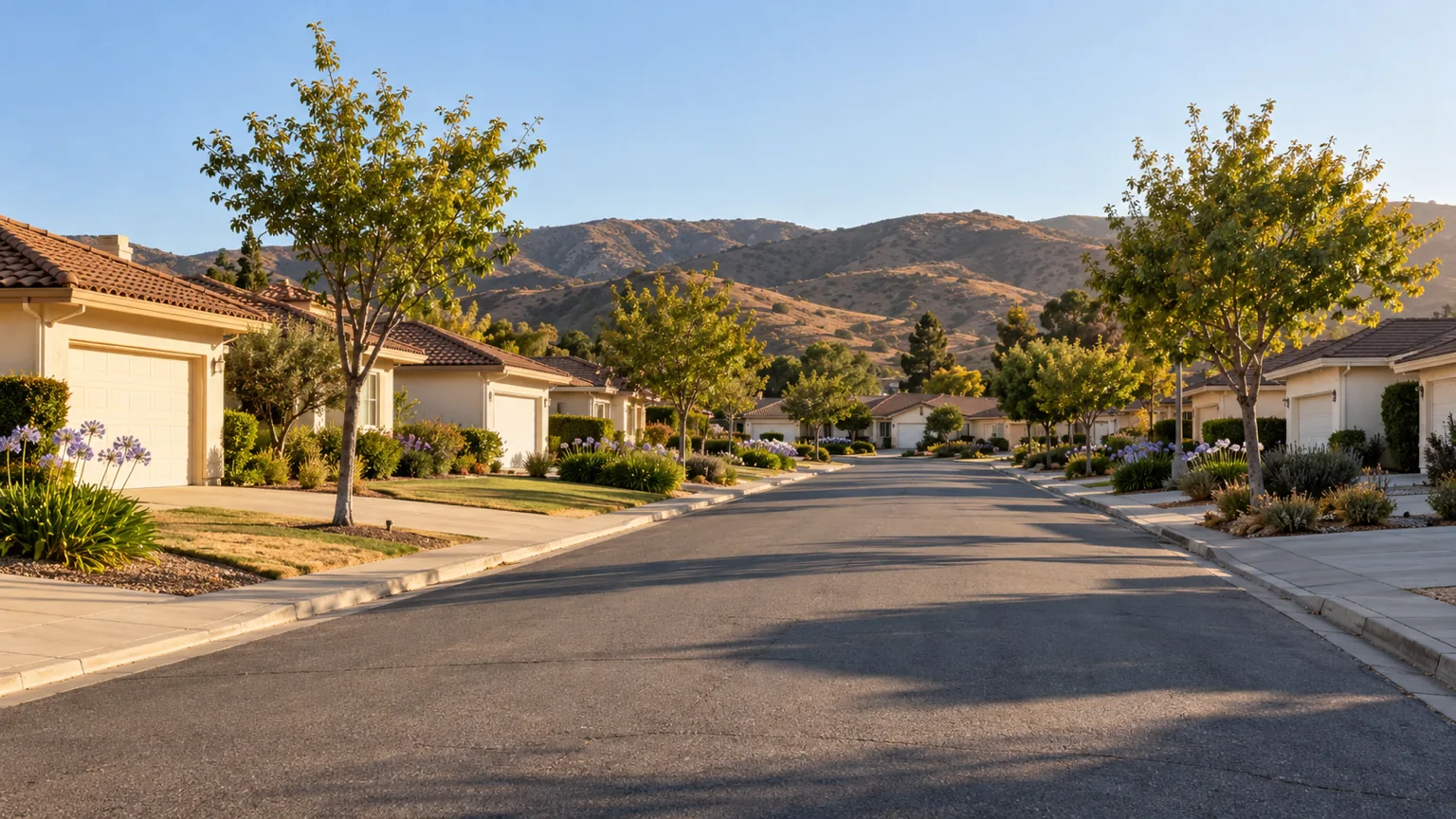 Single-storey stucco tract homes on a wide Camarillo street with brown foothills in the distance