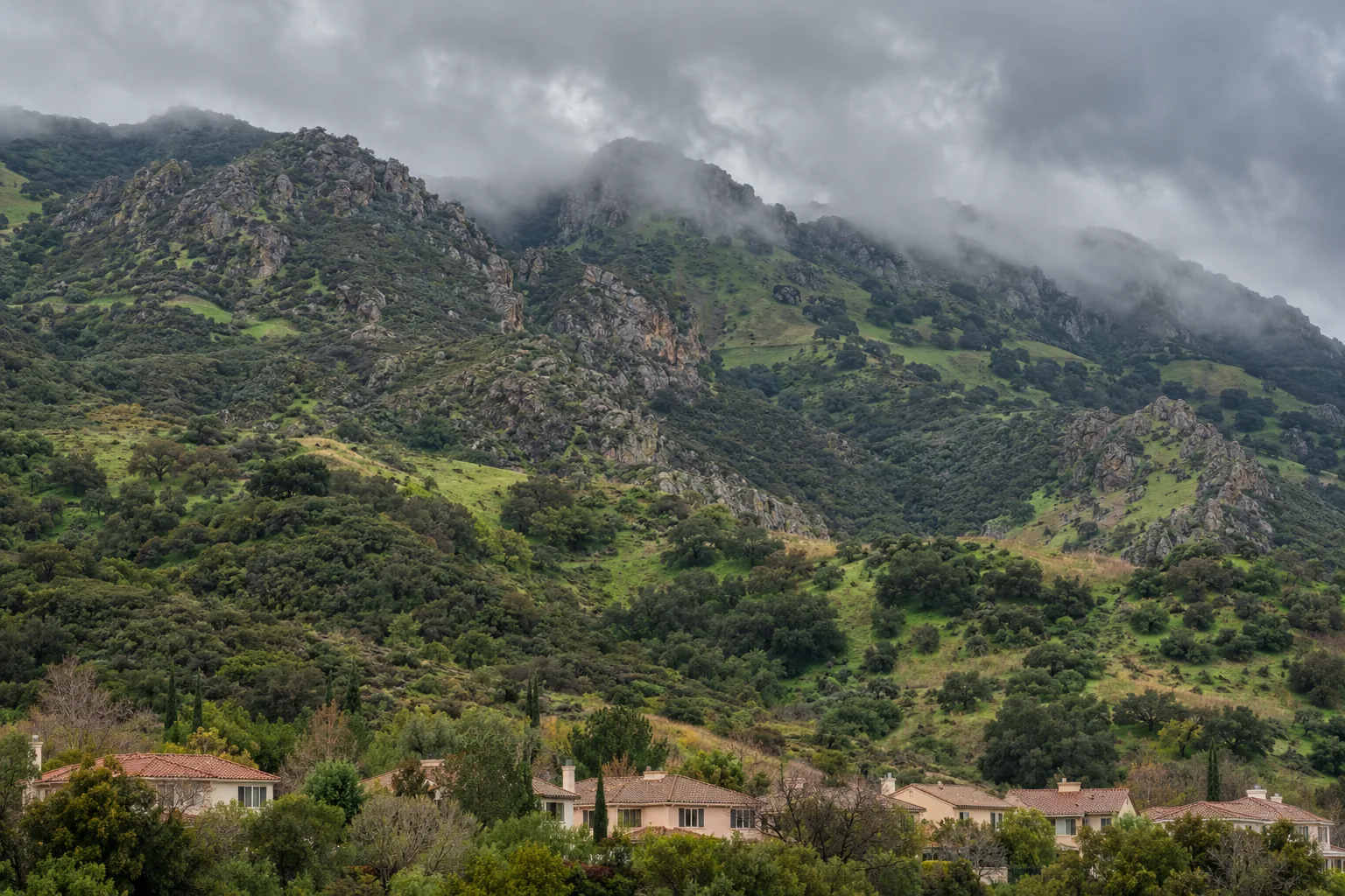 Chaparral slopes of the Santa Monica Mountains above Agoura Hills under low winter rain clouds